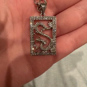 Silver jeweled dragon pendant and chain.